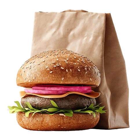 Taze malzemelerle dolu bir kağıt poşetin ve susamlı ekmeğin önünde duran bir hamburger.